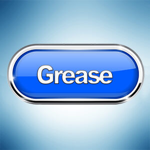 A glossy blue button with the word "Grease" inscribed in the center, set against a light blue background.